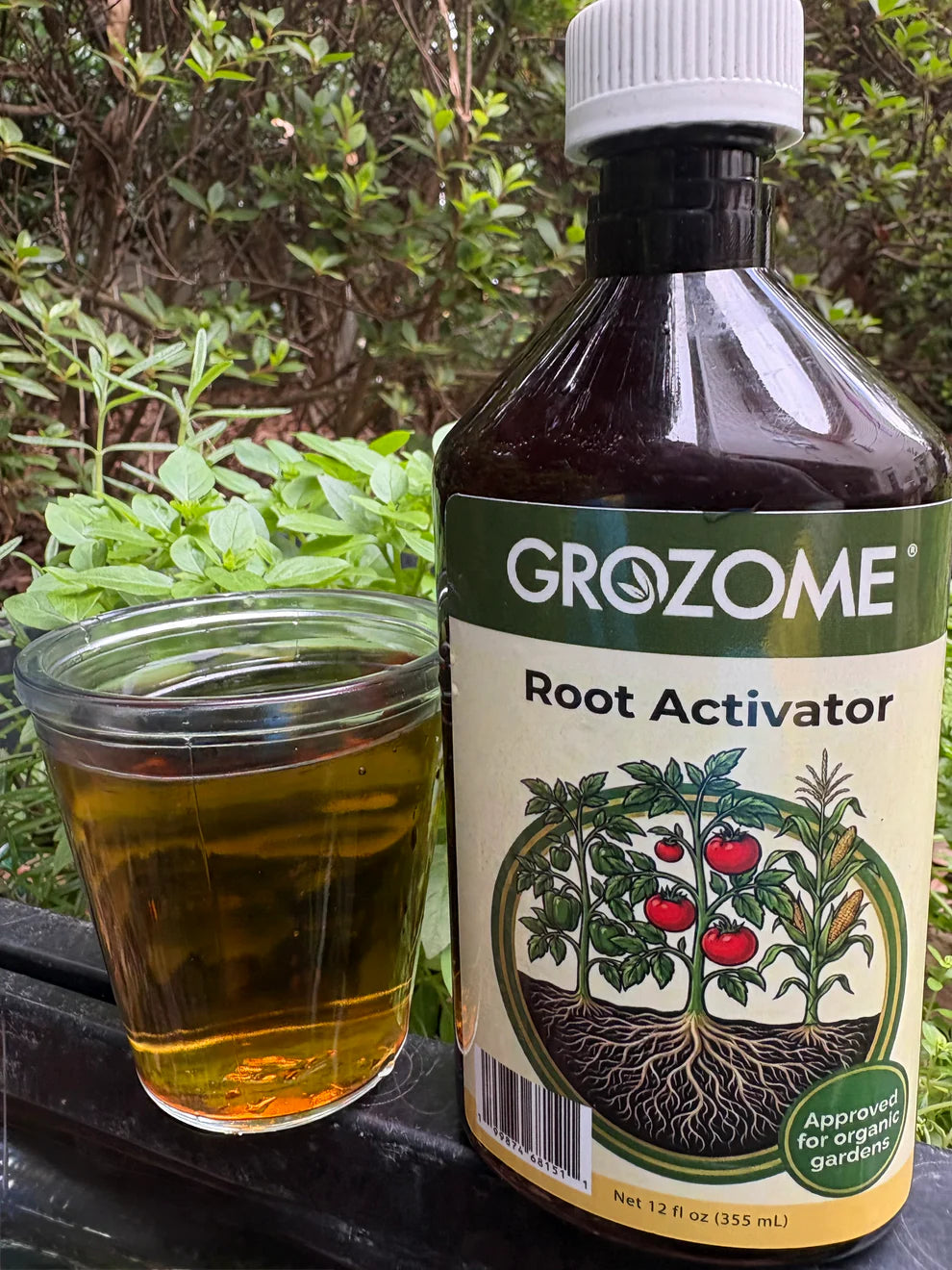 GroZome Root Activator bottle with a glass of liquid on a natural background